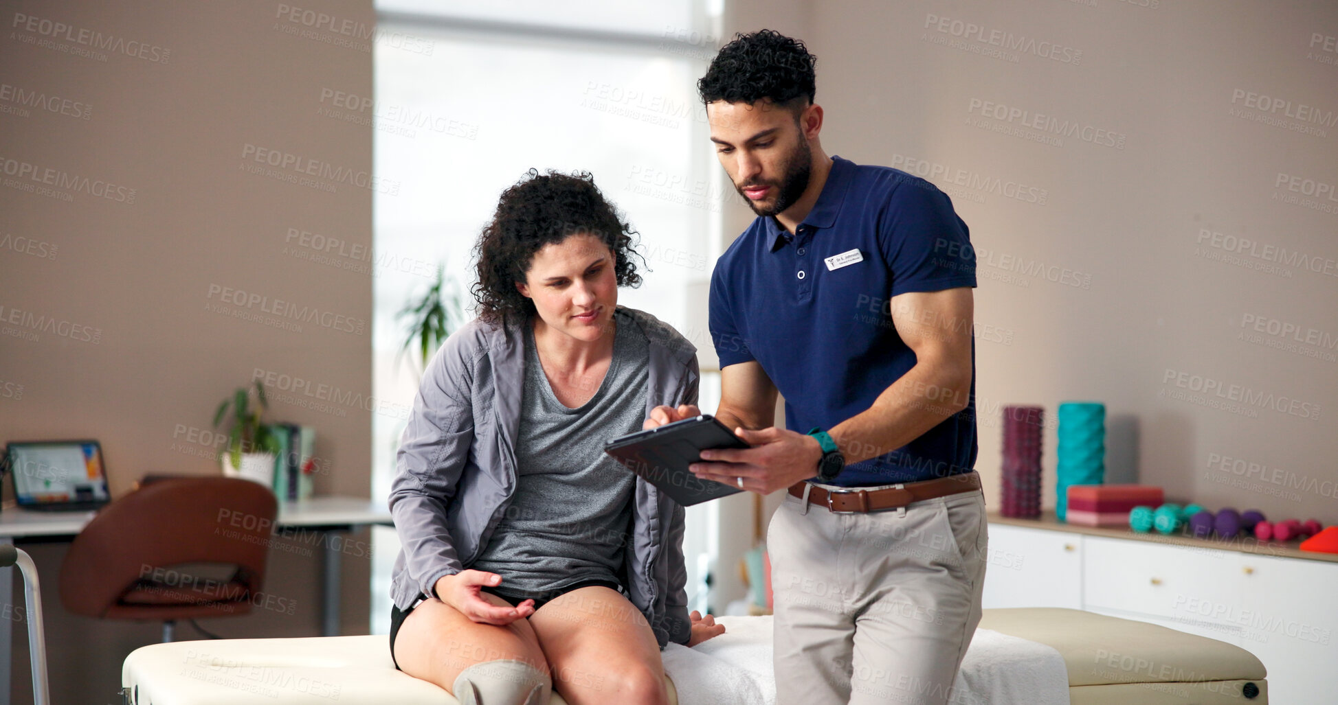 Buy stock photo Amputee, woman and physiotherapist with tablet in office for checkup, medical results and recovery. Prosthetic leg, digital and person with disability for physical therapy, report and rehabilitation