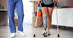 Physiotherapist, patient or crutches with prosthetic leg for mobility training or balance in clinic. Client, therapist and helping person with a disability for muscle rehabilitation, recovery or aid