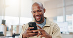 Phone, scroll and black man in office with smile, text message or email notification for good news. Happy, person and reading in workplace with tech, social media or online chat for positive feedback