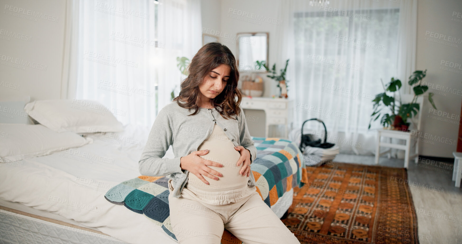 Buy stock photo Relax, pregnancy and woman on bed in home with peace, calm or weekend break with maternity leave. Motherhood, stomach and pregnant female person holding belly for prenatal bonding in bedroom at house