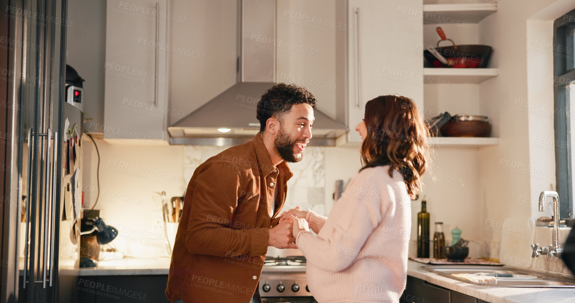 Buy stock photo Holding hands, dance or funny couple in kitchen for love, anniversary celebration or excited partner. Moving, woman and man in home with music, laugh and romantic rhythm for healthy relationship