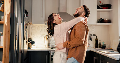Buy stock photo Hug, dance and funny couple in kitchen for love, anniversary celebration or excited partner. Moving, woman and man in home with music, laugh and embrace with romantic rhythm for healthy relationship
