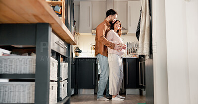 Buy stock photo Hug, couple or pregnant woman with smile in kitchen of home, connection or low angle for family growth. Love, embrace or happy people with tummy touch for bonding, maternity support or future parents