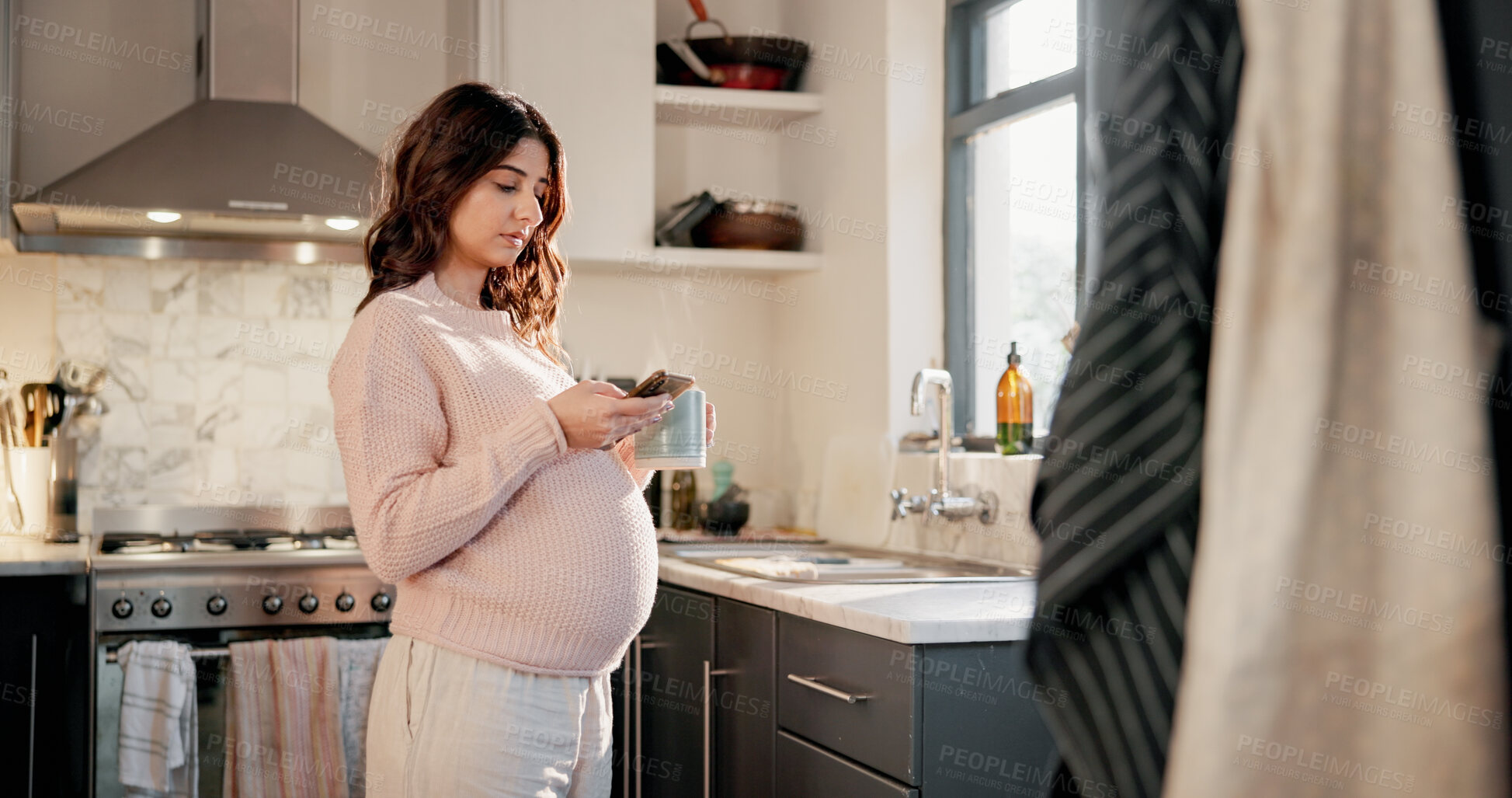 Buy stock photo Coffee, phone and pregnancy with woman in kitchen of home for family planning or research. App, drink and pregnant mother with baby bump in apartment for mobile review of parenting information