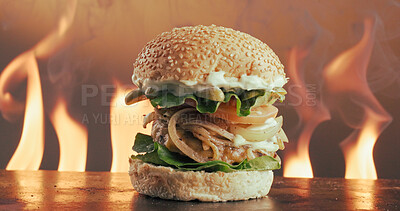 Buy stock photo Flame, grill and hamburger in restaurant with fast food, cuisine serving or catering for lunch dish. Fire, beef and bun in kitchen with seeds, vegetable ingredients and hospitality for takeaway meal.