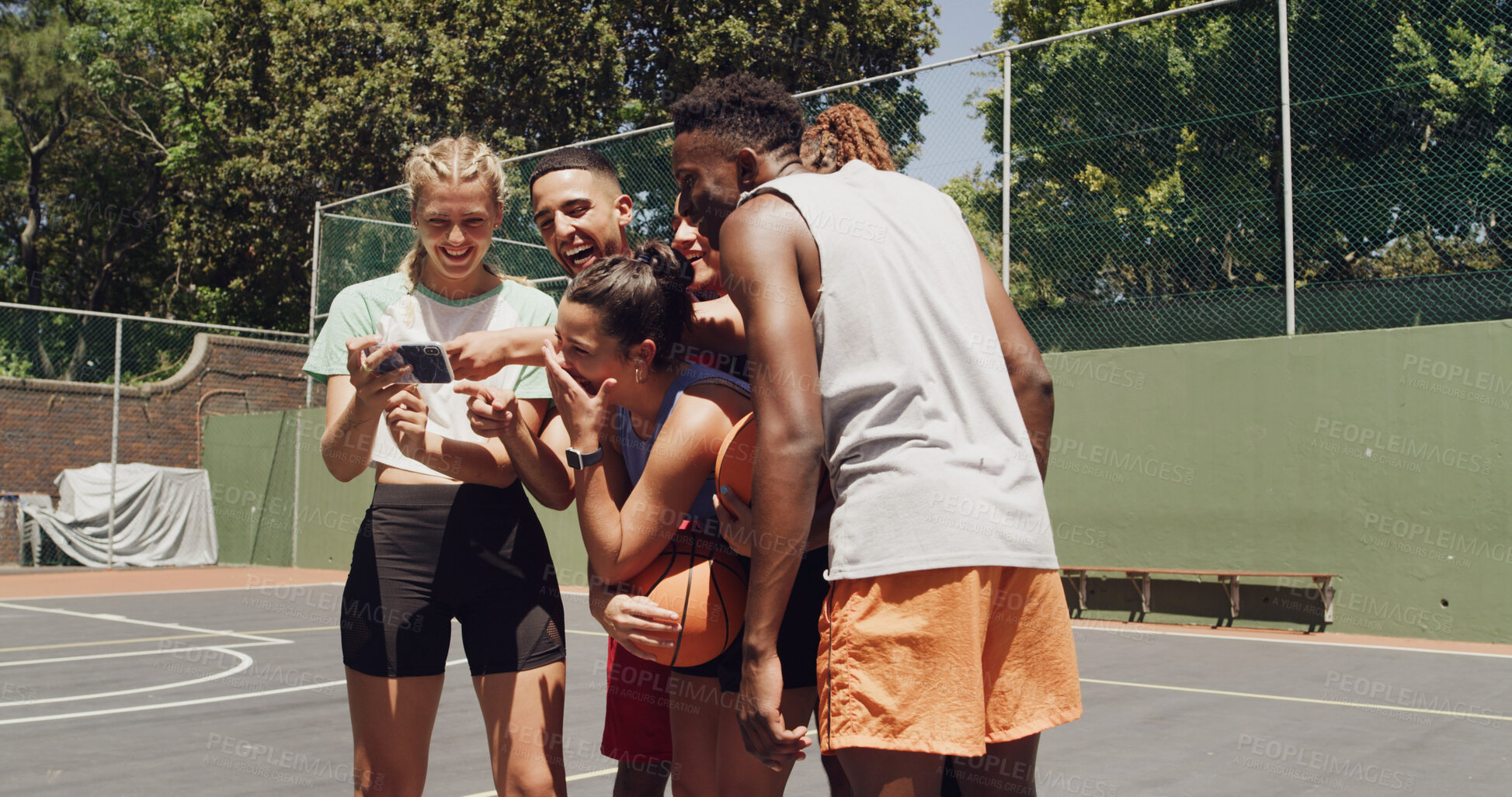 Buy stock photo Sports, team and people with phone, laugh and watching game on social media with basketball group. Fitness, comedy and friends with smartphone for videos, smile or scroll on web for entertainment