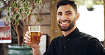 Portrait, man and smile with alcohol at pub for happy hour, order and customer service. Confident, male person and glass with beer, cultural experience and whiskey beverage at hospitality industry
