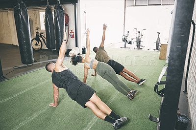 Buy stock photo Fitness, class and side plank with people in gym for core workout, personal trainer and health. Coaching, exercise club and training partner with men and woman in sports center for challenge