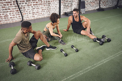 Buy stock photo Fitness, dumbbells and group of people in gym for conversation on workout, training or wellness. Equipment, friends and athletes with weights for exercise, active or challenge in sports center.