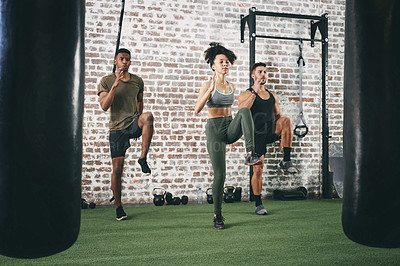 Buy stock photo Workout, class and high knees with people in gym for cardio challenge, fitness team and health. Coaching, training partner and wellness with group in sports center for personal trainer and exercise