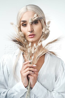 Buy stock photo Portrait, beauty and woman with wheat in studio, natural aesthetic and organic on white background. Plants, cosmetics and serious person with creative art, bunny tail grass or sustainable skincare