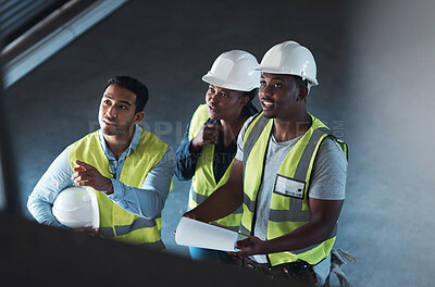 Buy stock photo Business people, pointing and building team with helmet in warehouse for structure improvement. Group, employees or contractors checking storage quality or inspection for construction or development