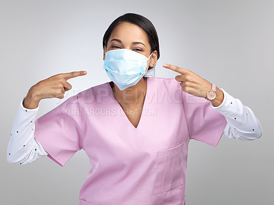 Buy stock photo Woman, nurse and pointing with face mask in studio for hygiene, medical safety and compliance. Portrait, person and hand gesture for pandemic reminder, healthcare protocol and ppe on white background