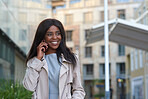 African american business woman using smartphone having phone call conversation in city