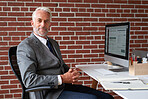 Portrait successful senior businessman smiling confident sitting at desk in office