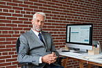 Portrait successful senior businessman smiling confident sitting at desk in office
