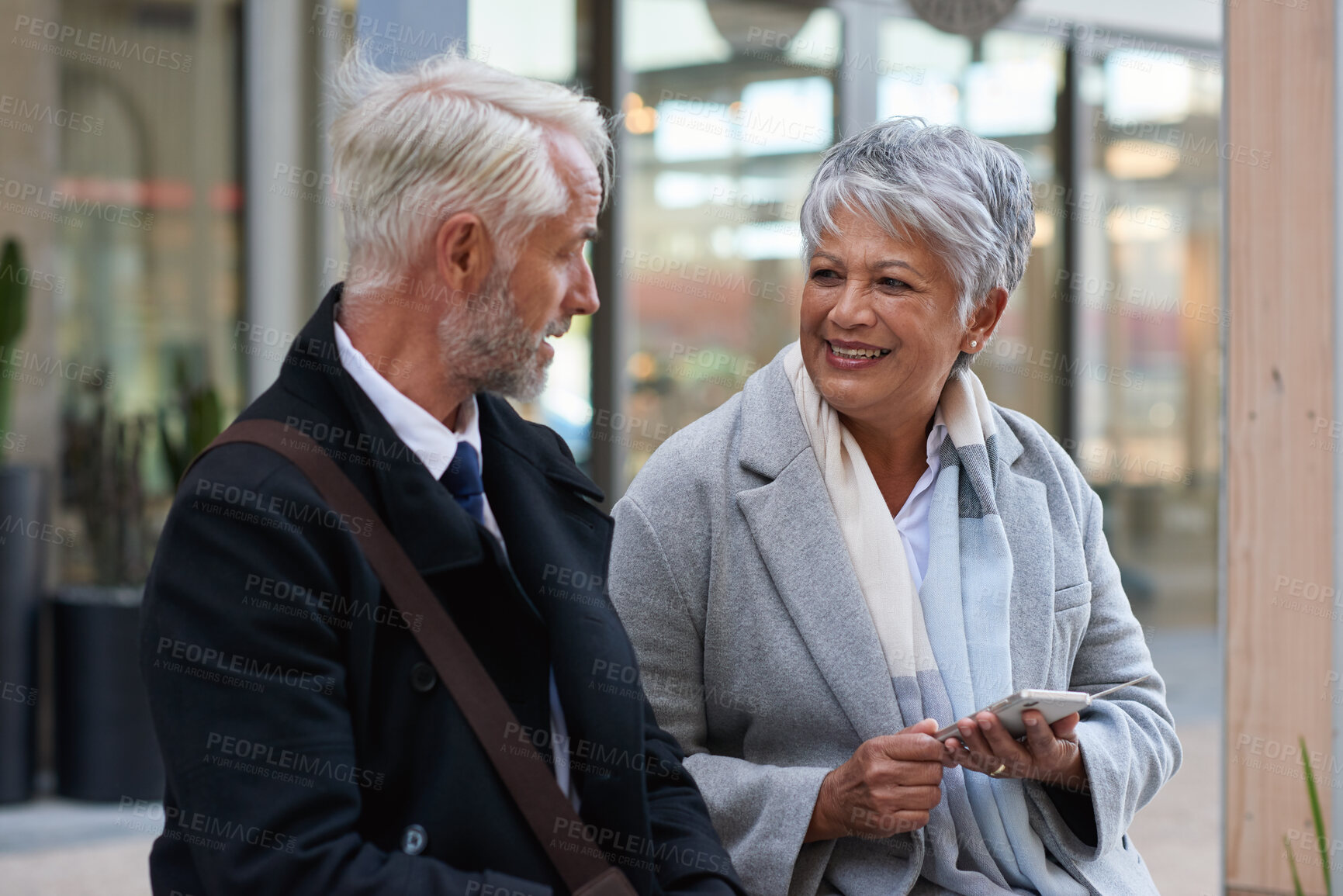 Buy stock photo Business, talking and people in city, smartphone for social media and break with communication. Outdoor, online humor or mature employees with discussion, connection and cellphone for website info