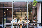 Mobile, friends and people at cafe window, relax and check social media post, bonding or hangout. Coffee shop, smile or group with phone for text, drink or customers chill together in city on weekend