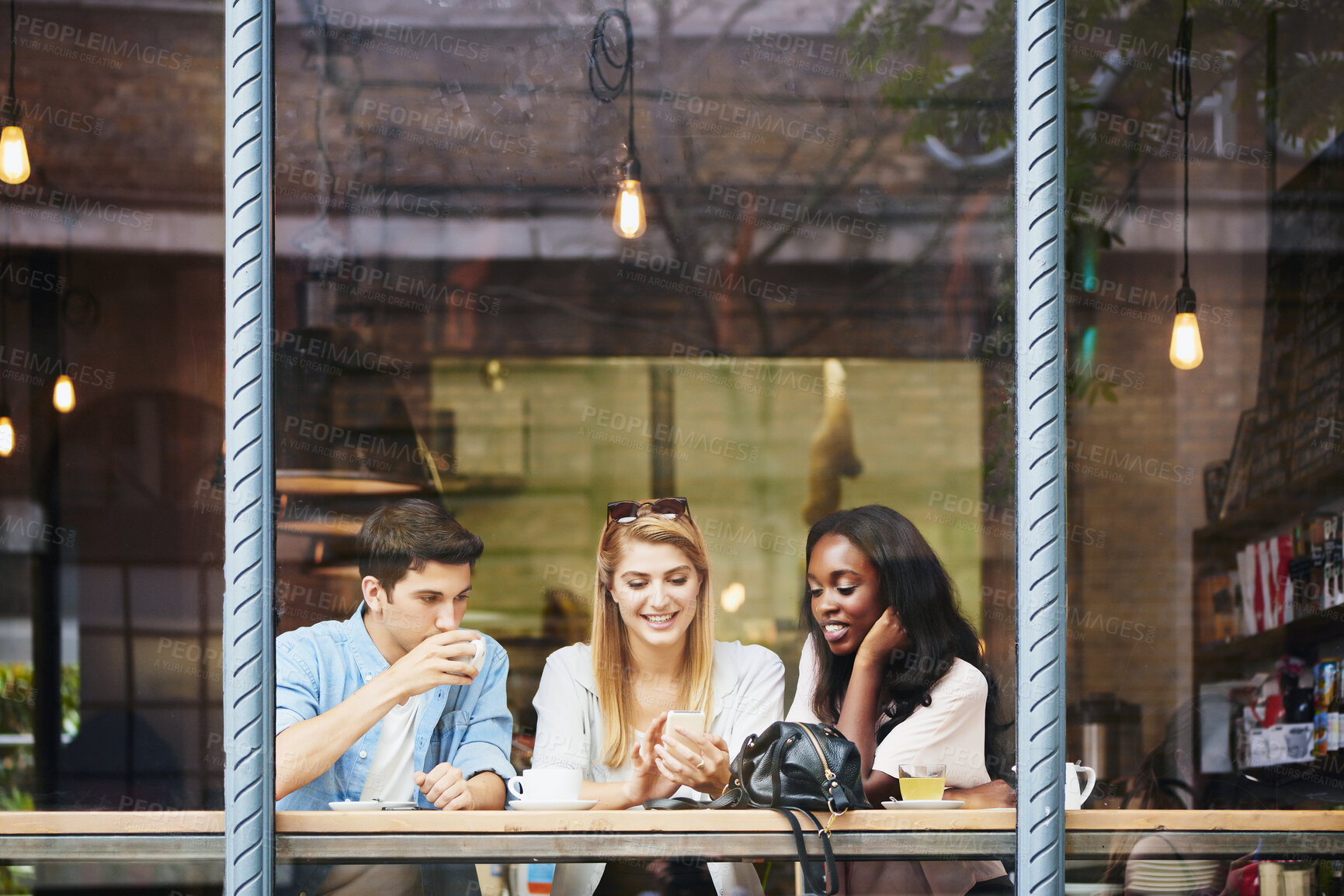 Buy stock photo Coffee shop, friends and people at window with mobile, relax and show post on social media. Cafe, smile and group with phone to share message, networking and customers hangout together on weekend
