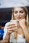 Cafe, window and woman with phone for chat, relax or communication with ai assistant on social media. Calm, person and online dating with virtual partner on mobile, scroll and reading message in shop