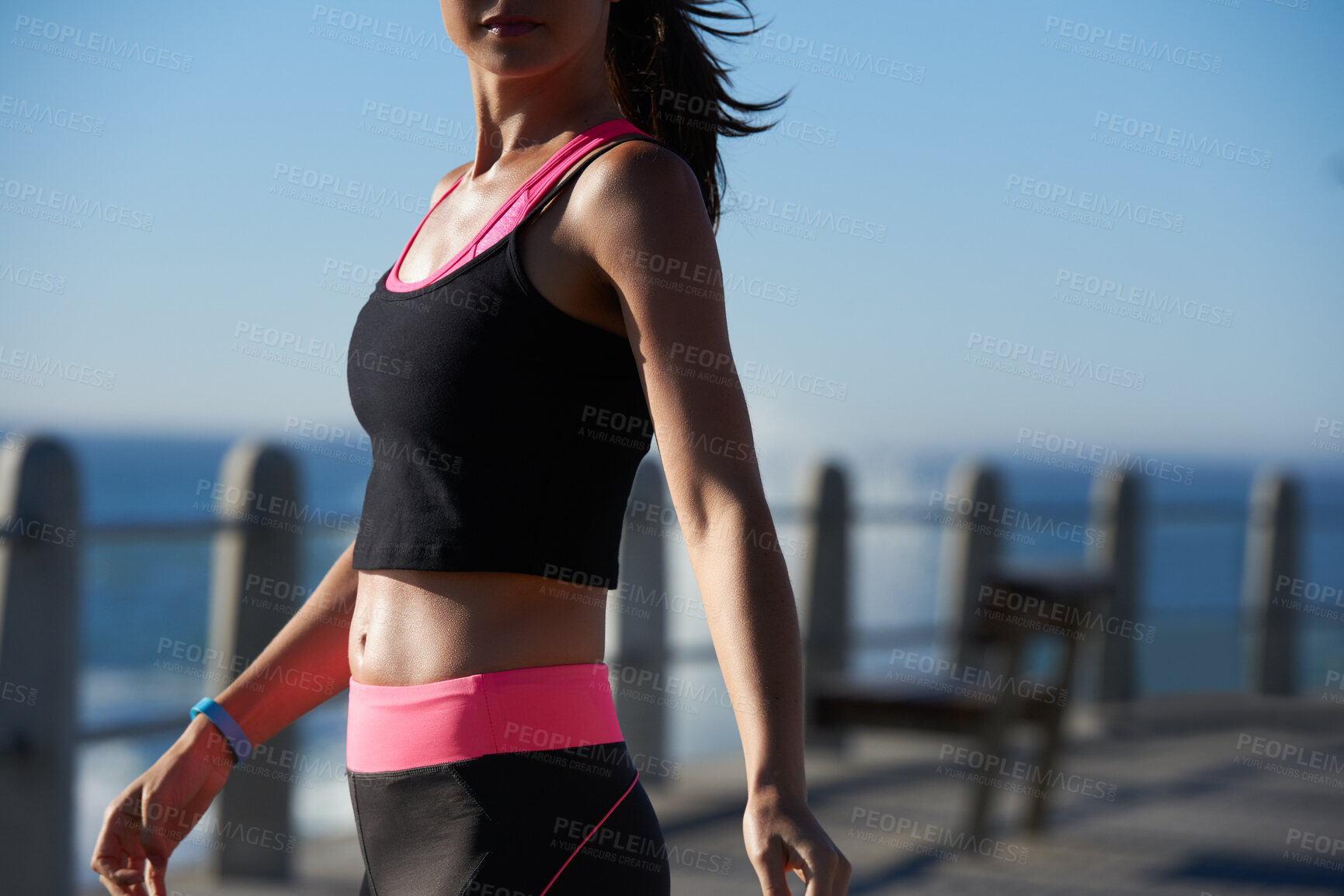 Buy stock photo Fitness, beach and body of woman for sports, exercise or active with wellness in summer. Runner, blue sky and female person on promenade by sea for cardio workout, training or health outdoor.