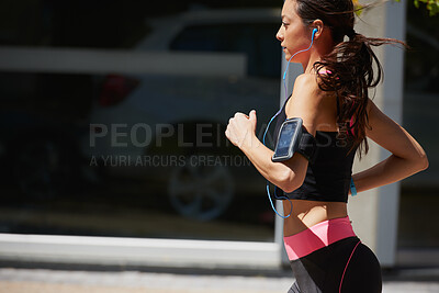 Buy stock photo Running, earphones and woman with fitness in city, cardio or streaming music for endurance training. Workout song, active or athlete with jog for pace practice, aerobic exercise or audio tech in town