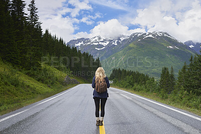 Buy stock photo Back, woman and hiking on road with mountain view, sightseeing and travel exploration for vacation. Person, backpack and adventure outdoor with scenery for winter holiday, tourist trip and wellness.
