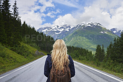 Buy stock photo Back, woman and hiking on road with mountains, adventure trip or exploration for sightseeing vacation. Person, backpack and travel outdoor with scenery for winter holiday, peace and tourist trekking.