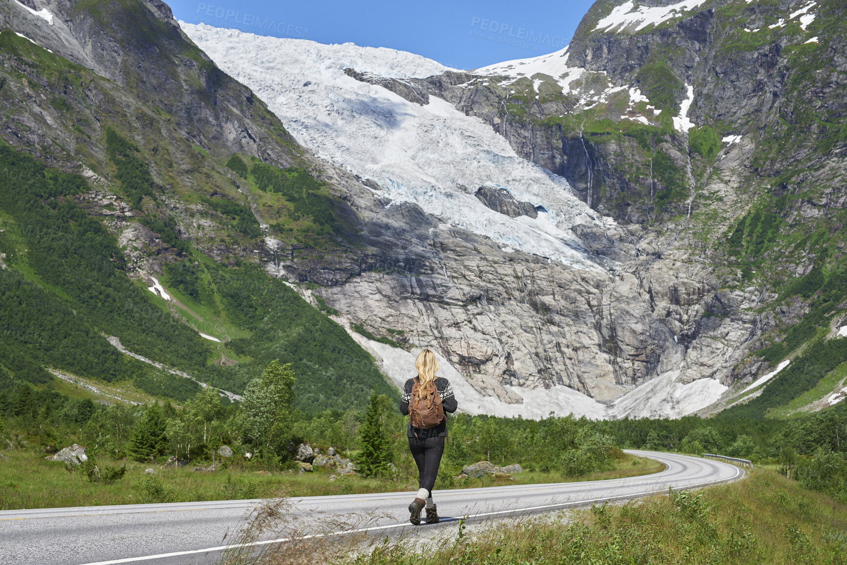 Buy stock photo Back, woman and hiking on road with backpack for travel, adventure and backpacking holiday. Mountain, female person and walking for trekking journey, glacier scenery and explore nature on vacation
