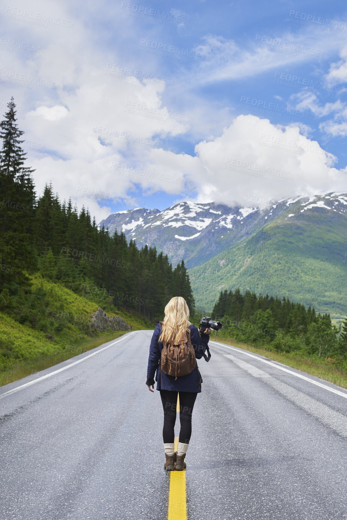 Buy stock photo Woman, backpack and camera on road with mountain view, sightseeing or travel exploration for vacation. Back, person and photographer outdoor with equipment for winter holiday, adventure and scenery.