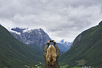 Adventure woman taking photo smart phone of glacial valley landscape on travel exploration for social media