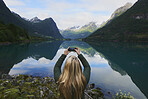 Adventure woman taking photo of beautiful nature mountail lake with smart phone travel explore discover