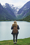Adventure backpacking woman enjoying view of majestic mountain lake explore travel discover beautiful earth