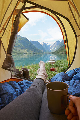Buy stock photo Feet, tent and camping at lake with coffee, holiday and relax for vacation with mountain view. POV, campsite or hand of person with tea outdoor by water for wanderlust on adventure, travel and rest