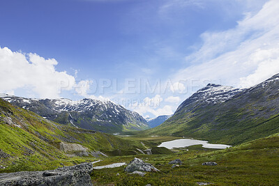 Buy stock photo Blue sky, mountain and nature with grass field of landscape, glacial valley or view in Norway. Empty, space and wilderness of cold river stream with greenery, snow or ice lake for outdoor destination