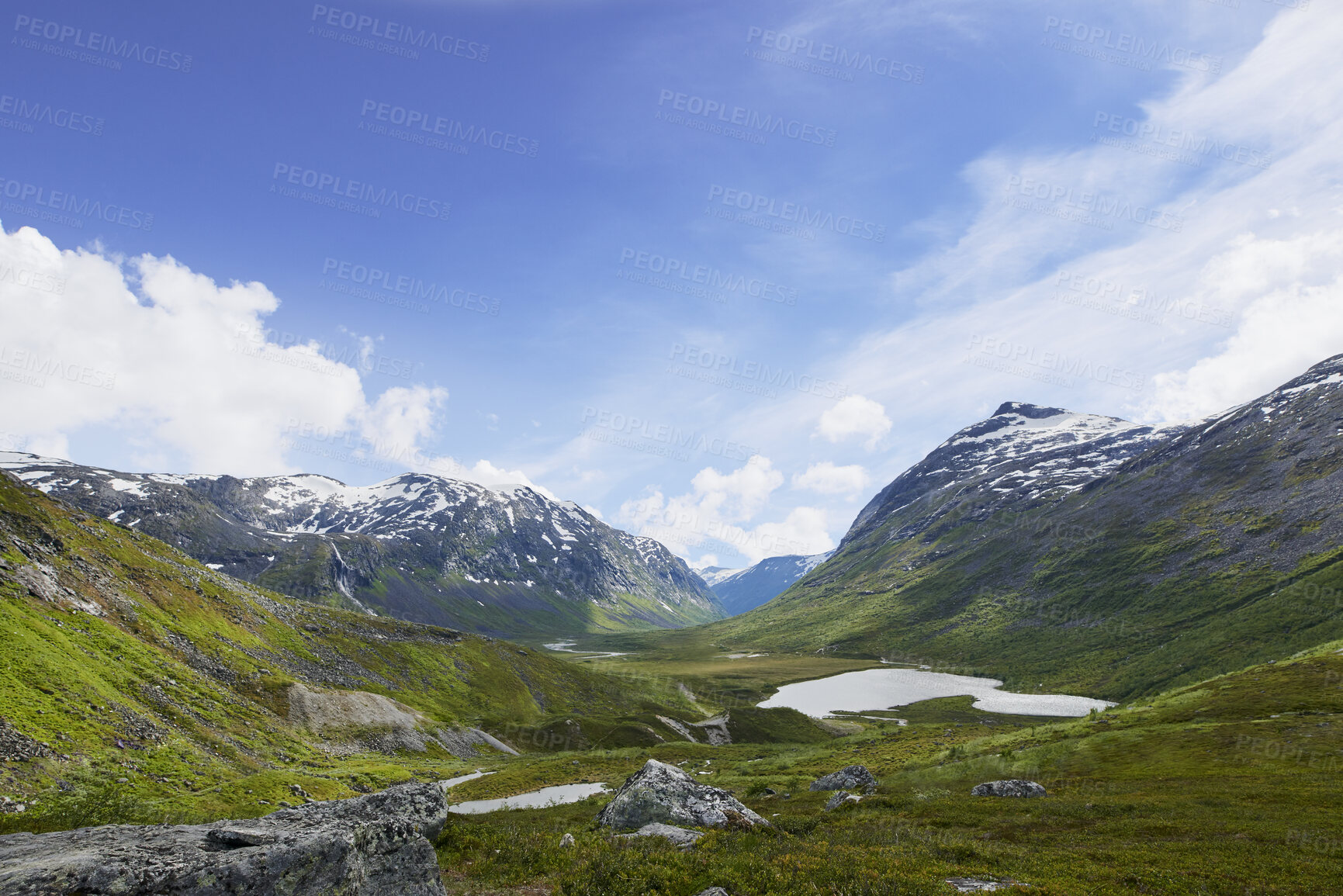 Buy stock photo Blue sky, mountain and nature with grass field of landscape, glacial valley or view in Norway. Empty, space and wilderness of cold river stream with greenery, snow or ice lake for outdoor destination