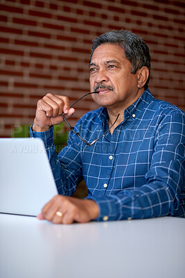 Buy stock photo Laptop, thinking and mature businessman in office, marketing decision and campaign inspiration. Computer, idea and creative director at work for planning ads, brand awareness or insight with glasses