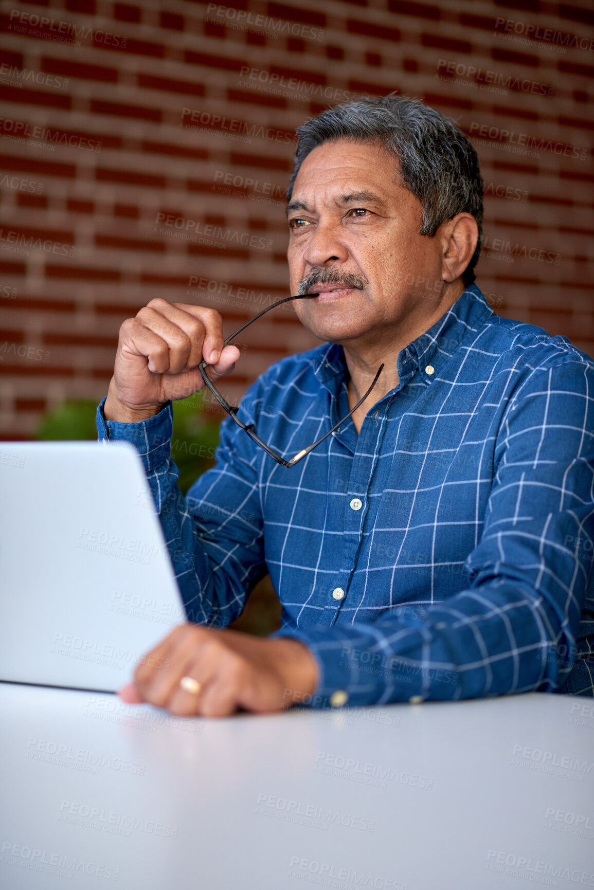 Buy stock photo Laptop, thinking and mature businessman in office, marketing decision and campaign inspiration. Computer, idea and creative director at work for planning ads, brand awareness or insight with glasses