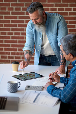 Buy stock photo two businessmen using tablet computer discussing financial graph data on mobile touchscreen device in meeting