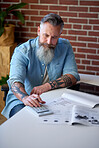 mature businessman reading financial documents using calculator planning solution with market statistics
