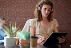 beautiful woman using tablet computer with stylus pen listening to music wearing headphones