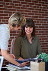 two business womenn sharing documents in office colleagues working together on project