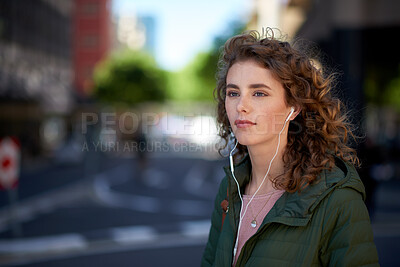Buy stock photo Woman, tourist and travel with earphones in city for music, audio streaming or outdoor playlist. Female person, traveler or listening with sound app for commute, tourism or journey in an urban town