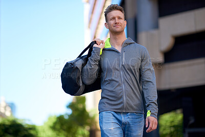 Buy stock photo Man, fitness and walking with gym bag in city for workout equipment or outdoor preparation. Active, male person or athlete getting ready with exercise gear for health and wellness in an urban town