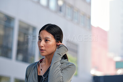 Buy stock photo Fitness, music and woman in city with earphones, motivation playlist or streaming sound for exercise. Runner, outdoor and Asian person with audio song, sports subscription or listening to radio