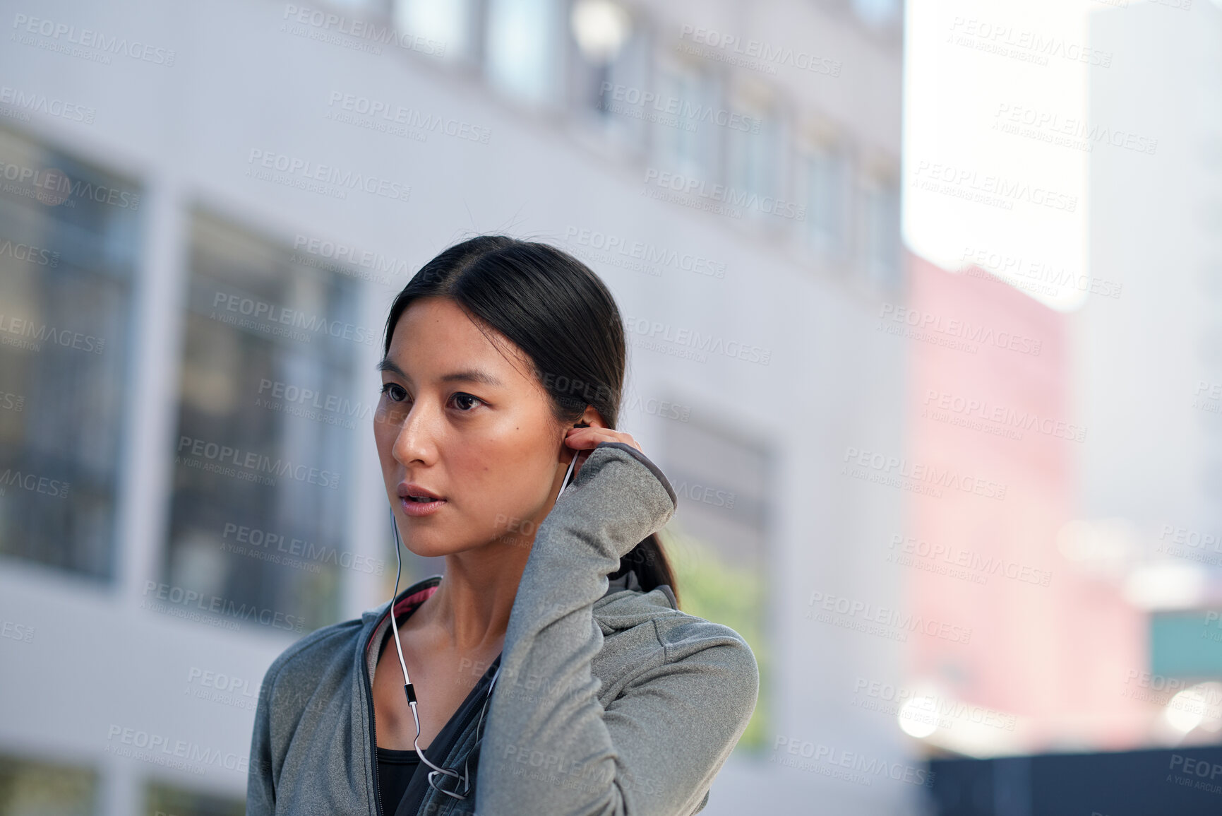 Buy stock photo Fitness, music and woman in city with earphones, motivation playlist or streaming sound for exercise. Runner, outdoor and Asian person with audio song, sports subscription or listening to radio
