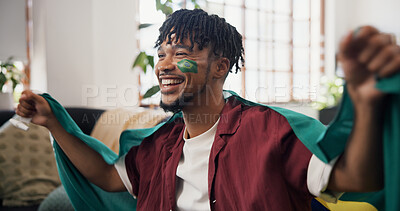 Buy stock photo Man, Brazil flag and celebration in lounge, soccer and cheering for champion, smile and winning. Fan, happiness and person in home, football and excited for score lead, tournament and supporter
