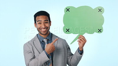 Buy stock photo Happy man, portrait and pointing with speech bubble in studio for advertising on a blue background. Businessman, employee or smile with icon, shape or mockup space for social media or marketing