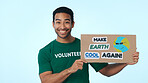 Volunteer, poster and portrait of man in studio for climate change, conservation and global warming. Space, happy and person with sign for earth day, ecology and recycling campaign on blue background