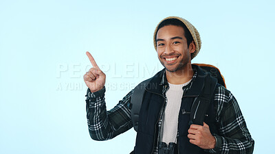 Buy stock photo Hiking, pointing or man with advertising in studio for trail event, travel marketing or promo offer. Portrait, happy hiker or show space for trekking tips, backpacker deal and info on blue background